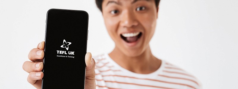 Asian man holding phone to camera